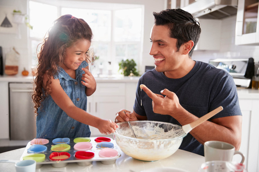 father and daughter baking cupcakes