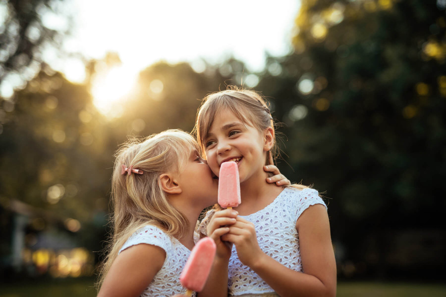 young girls eating popsicles