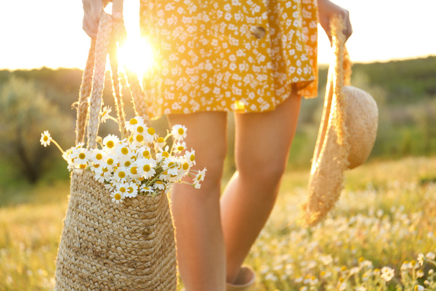 woman walking through a grassy field